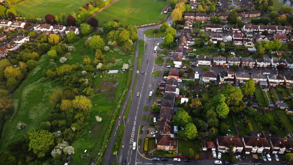 An aerial view of a residential neighborhood with well-maintained gardens and green spaces along Chatsworth Road and Clapton Common E9. The image showcases a variety of garden layouts, including lush 
